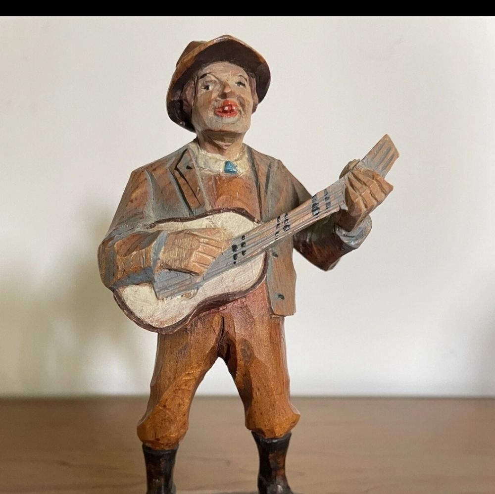 This Italian Anri wooden hand-carved man playing guitar figurine